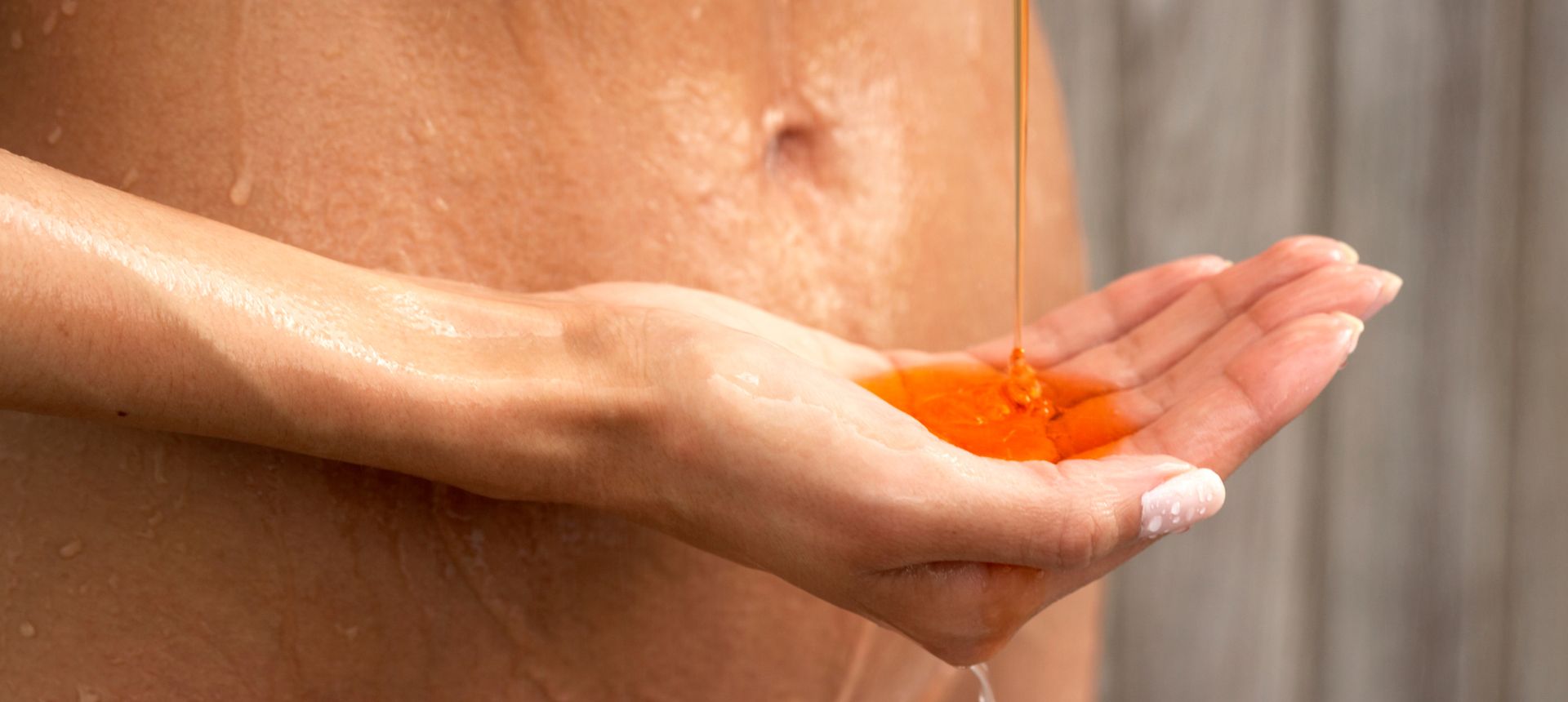 woman squirting body wash into hand