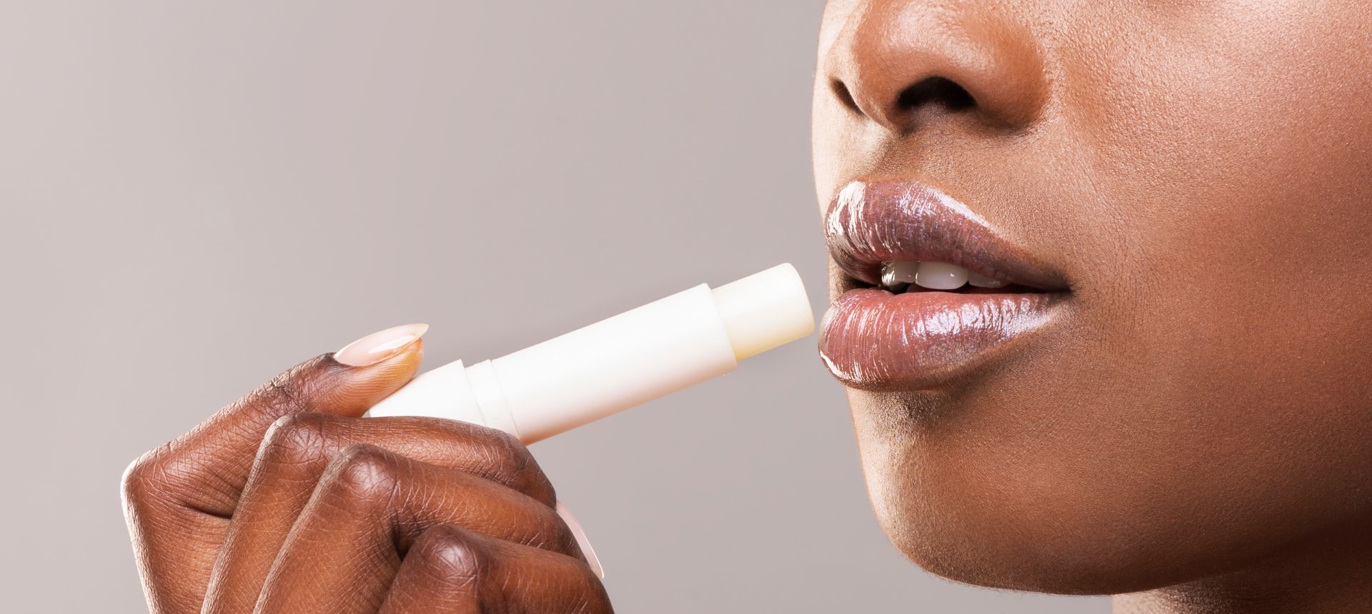 woman applying lip balm