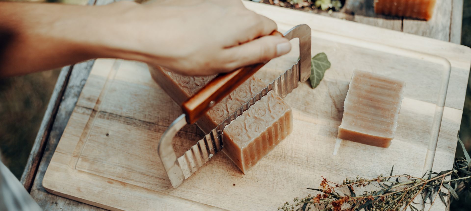 cutting a bar of handmade soap with a crinkle cutter