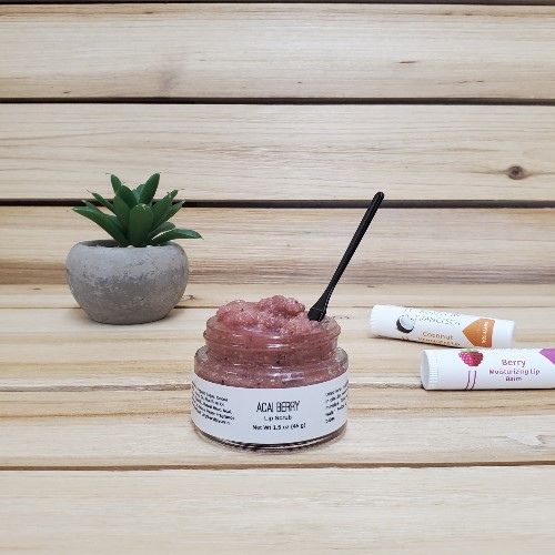 Acai Berry Lip Scrub open top next to plant and lip balm