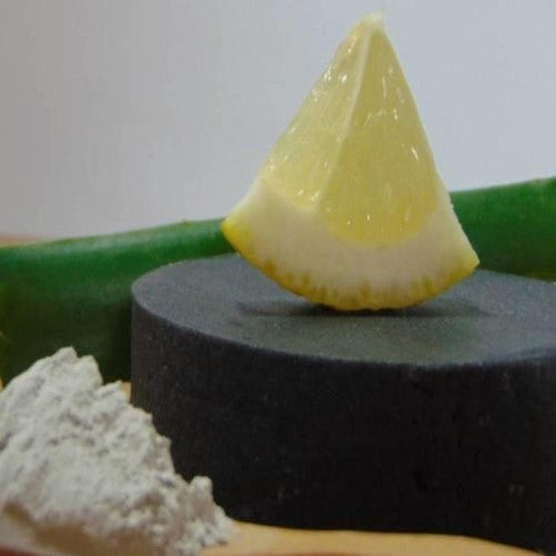 Activated Charcoal Soap  with a lemon wedge on top