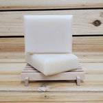 2 bars of bergamot soap on a wood soap dish