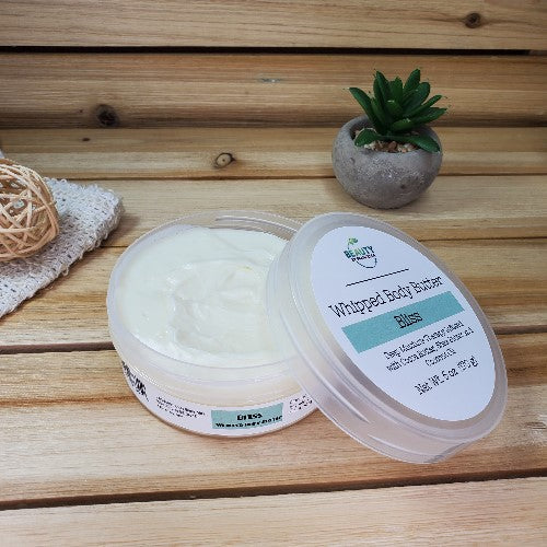 Bliss Whipped Body Butter Next to Plant