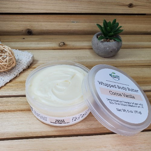 Cocoa Vanilla Whipped Body Butter Next to Plant