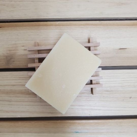 Sweet Cedarwood Soap on wood soap dish top view