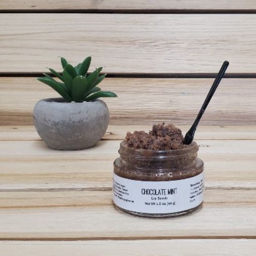 Chocolate Mint Lip Scrub next to plant open lid