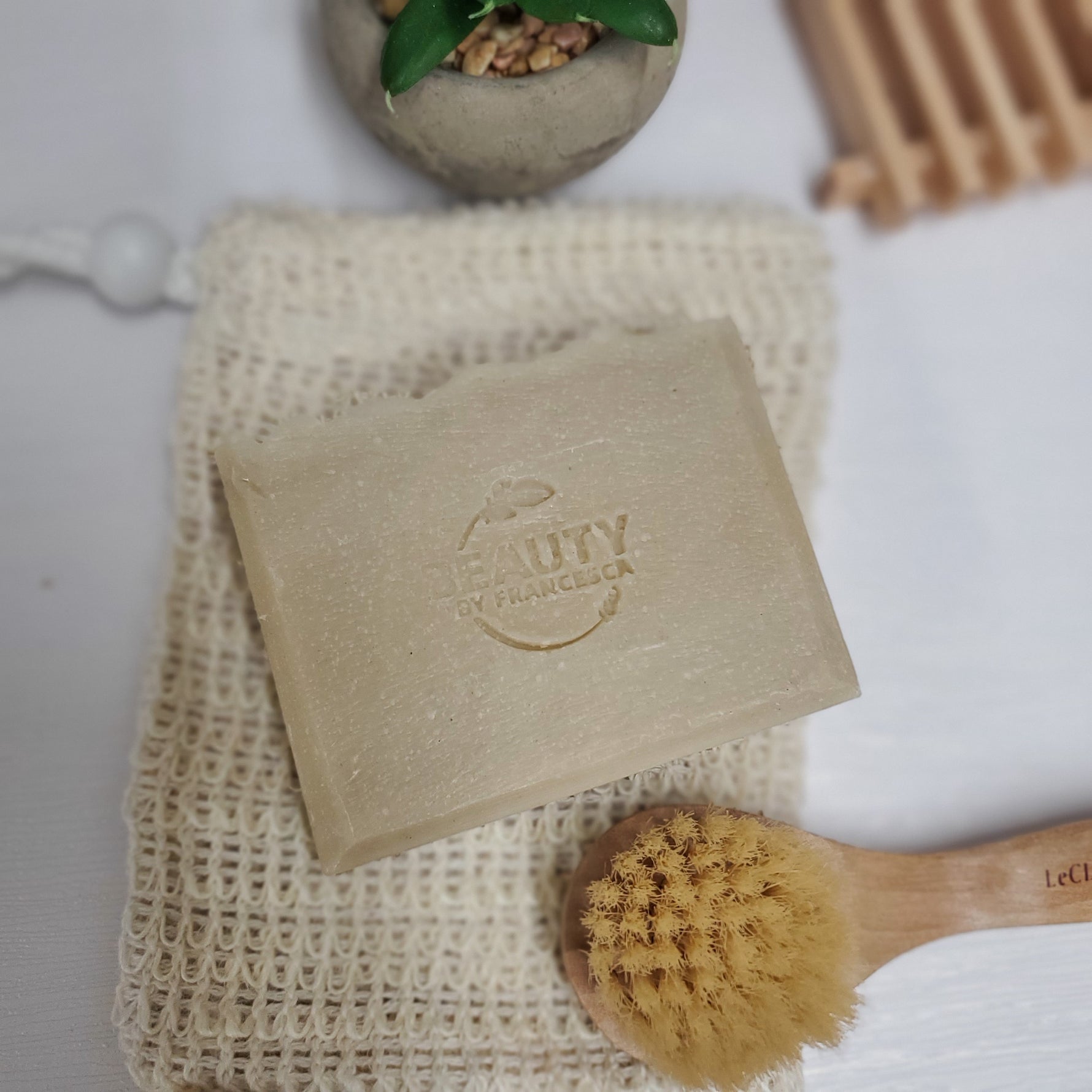 Eucalyptus Handmade Soap on reusable soap holder near tiny face brush